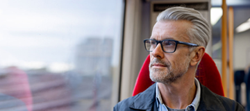 Photo of a man as he looks out of a train window